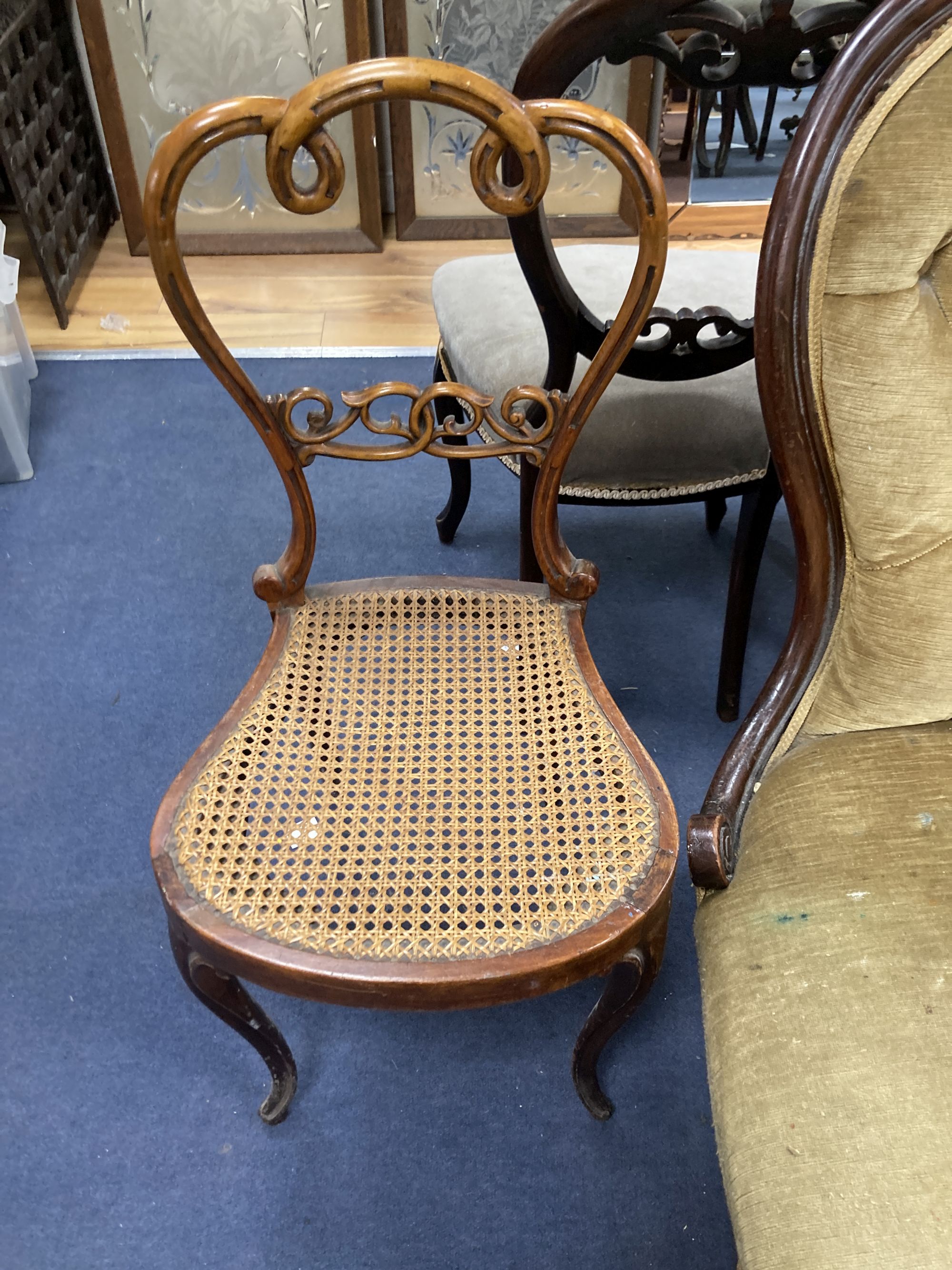 A Victorian mahogany open armchair, a Victorian nursing chair, five balloon back dining chairs and a caned chair